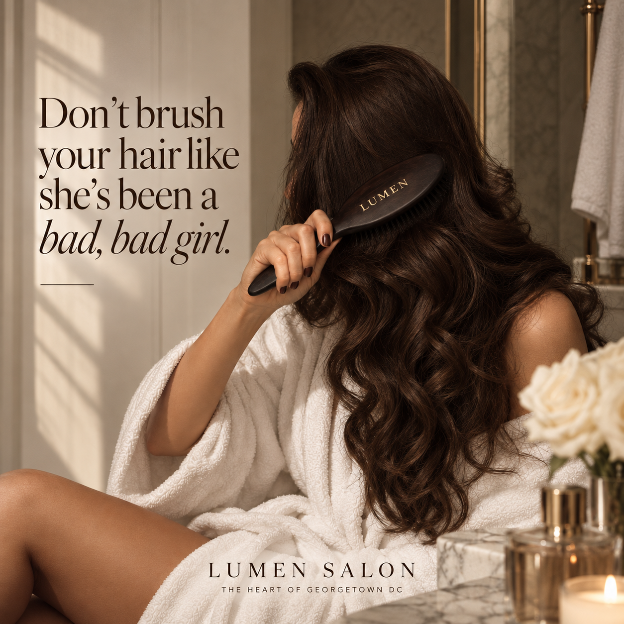 Woman gently brushing long brunette hair with tips for preventing hair breakage from Lumen Salon in Georgetown DC.